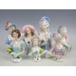 A collection of porcelain pin ladies