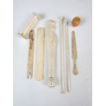 A selection of antique bone, mother of pearl and coquilla nut carved objects