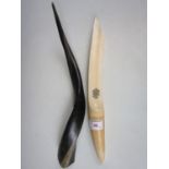 A Victorian ivory paperknife (a/f) together with an African horn oliphant