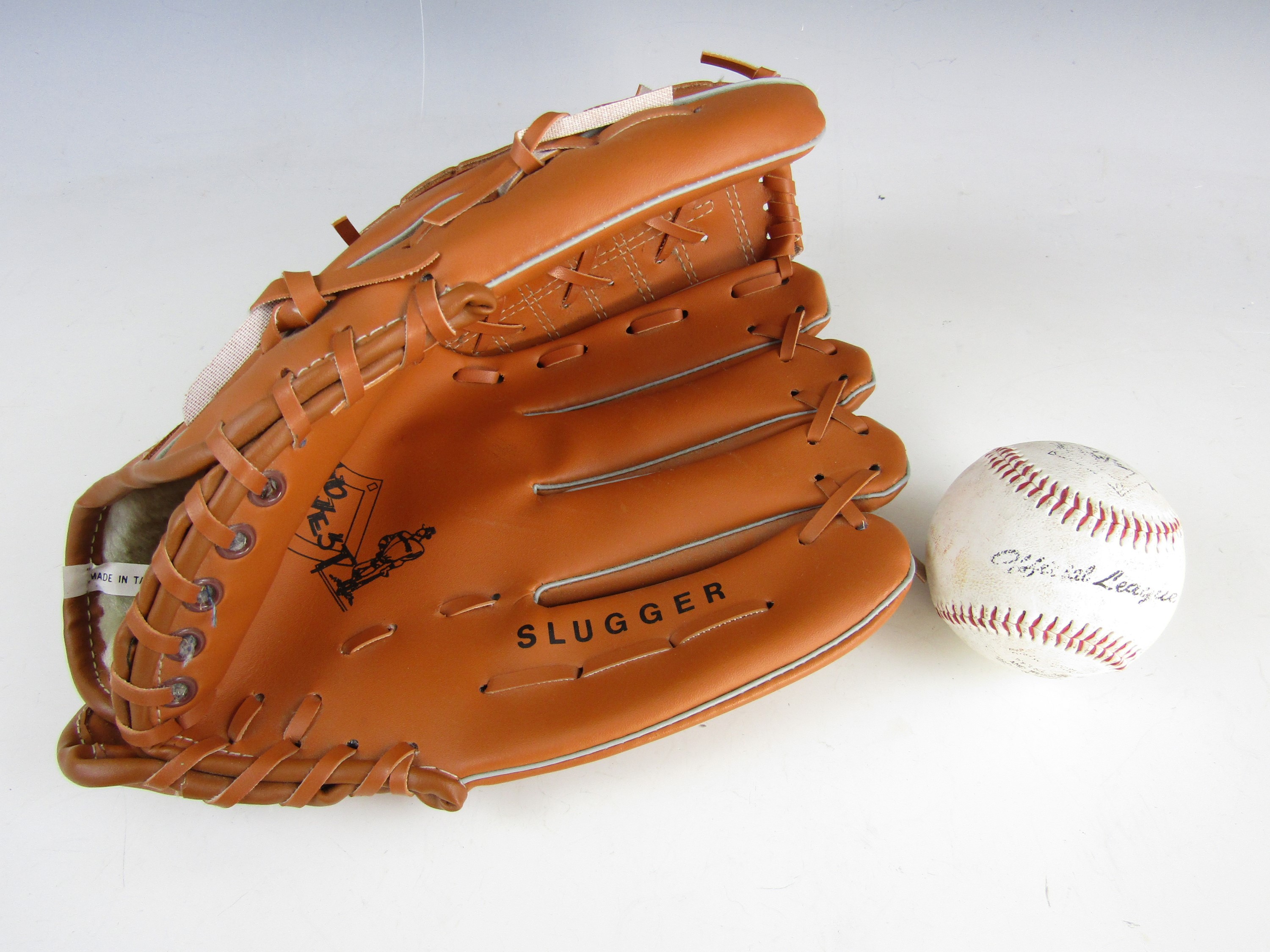 A Mid West Slugger baseball glove with ball