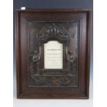 A Great War bronzed plaster memorial plaque within oak frame, bearing a bi-lingual Welsh and English