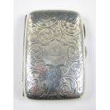 A Victorian silver cigarette case, of subtly contoured cushion shape, densely engraved with