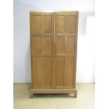 Attributed to the workshop of Arthur Simpson of Kendal An arts-and-crafts joined-oak wardrobe, of