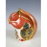 A boxed Royal Crown Derby bone china Red Squirrel paperweight, with gold stopper, signed and dated