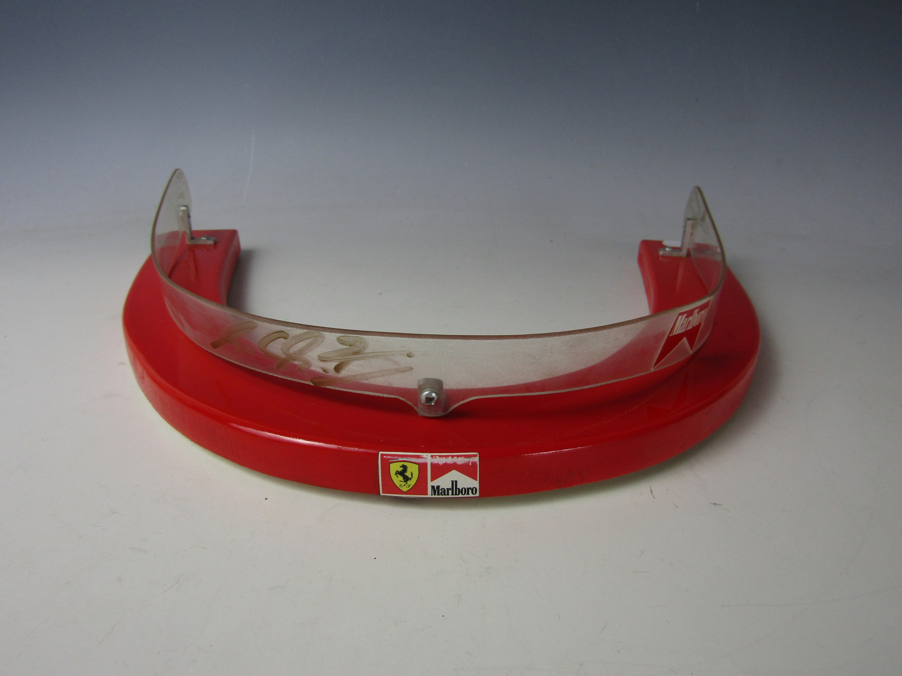 The perspex wind shield from Michael Schumacher's Formula 1 Ferrari signed by Giancarlo