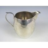 A George V silver jug, of barrel form with scroll handle, London, 1929, 191g