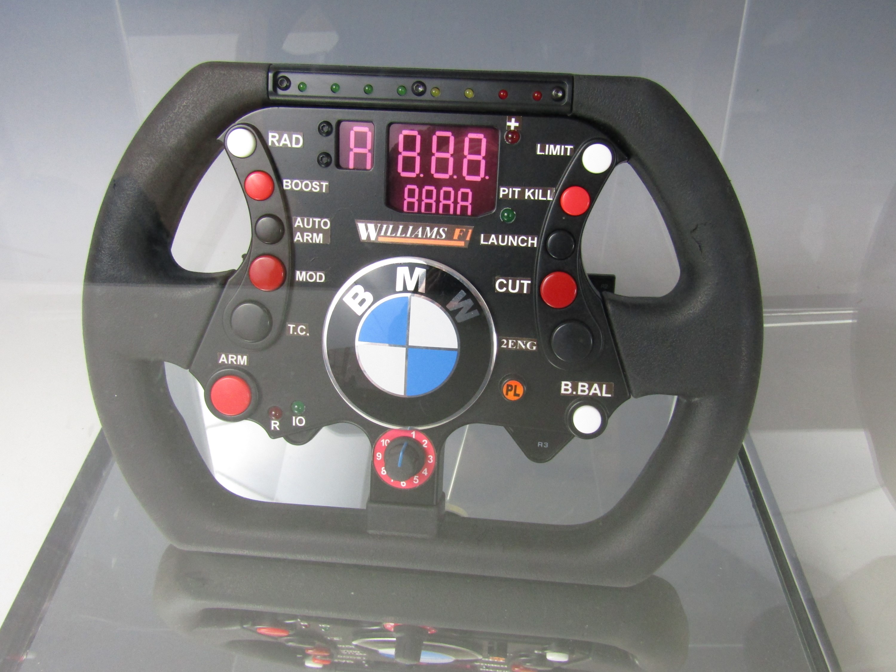 A cased replica Williams Formula 1 steering wheel, 32 x 32 x 33 cm - Image 2 of 2