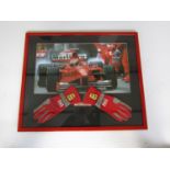 A framed display incorporating Eddie Irvine's signed King Dragon Formula 1 racing gloves used during