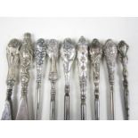 Nine assorted late 19th / early 20th Century silver handled button hooks and shoe horns