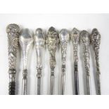 Eight assorted late 19th / early 20th Century silver handled button hooks