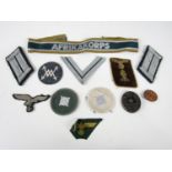 A group of German Third Reich insignia including an Afrikakorps cuff title, Army officers' litzen,