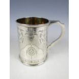 A Victorian silver presentation tankard, decoratively engraved with stylized floral borders