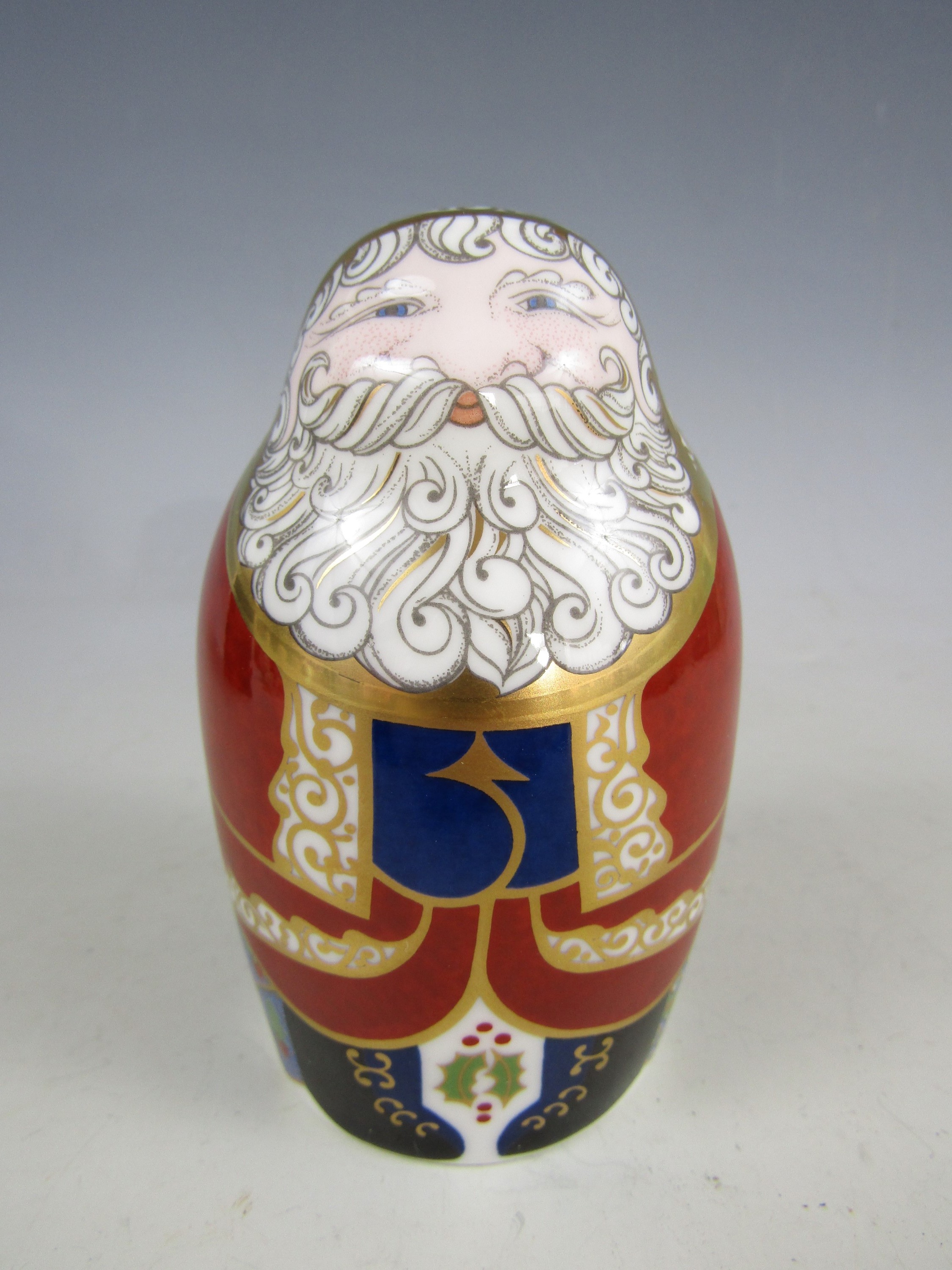 A boxed Royal Crown Derby bone china Santa Claus paperweight, with gold stopper, signed and dated by