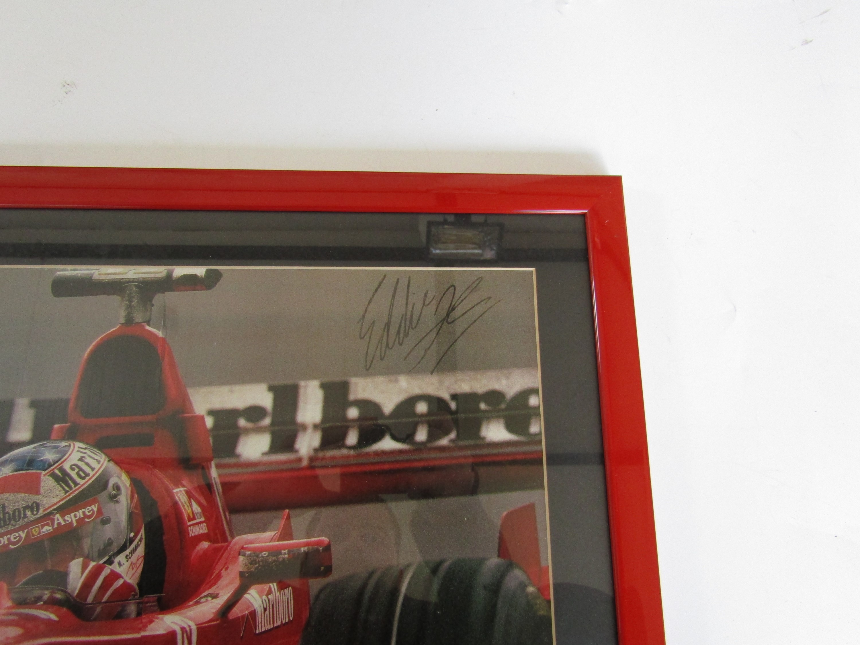 A framed magazine centrefold featuring Michael Schumacher in his Formula 1 Ferrari at Silverstone - Image 2 of 2