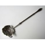 A George II white-metal punch ladle, the oval shaped bowl being lobed and repousse moulded in