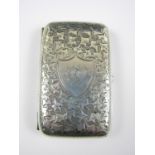 A George V silver cigarette case, of subtly contoured cushion shape, densely engraved with ivy