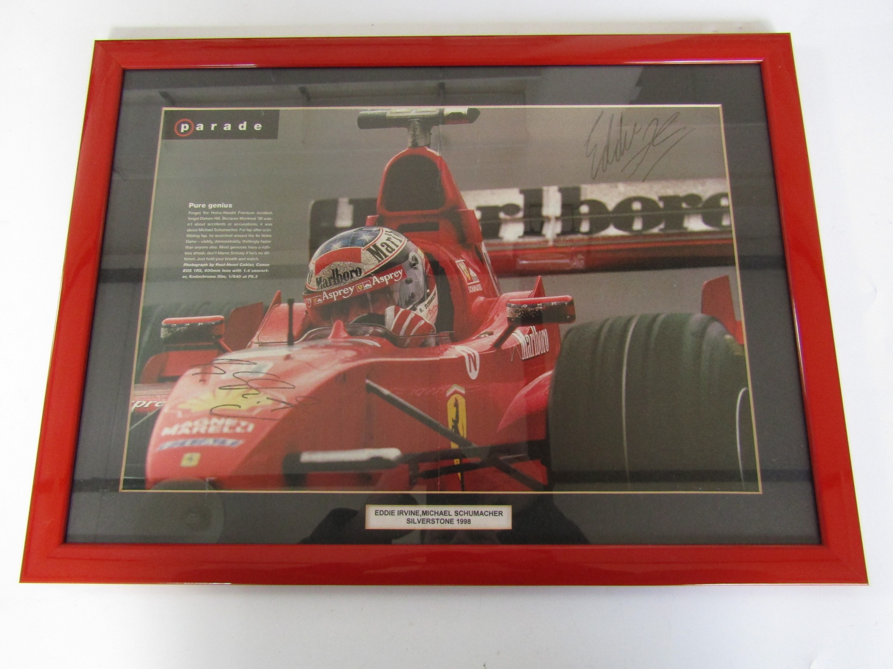 A framed magazine centrefold featuring Michael Schumacher in his Formula 1 Ferrari at Silverstone