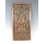 A 19th Century carved oak panel, incorporating urn, swags and bell flowers, signed verso L.C.