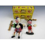 Two vintage Pelham Puppets, Sandy MacBoozle, and Pinocchio, each in original yellow cartons, circa