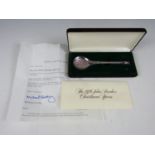 A cased 1976 John Pinches silver seal top Christmas spoon, the bowl moulded in depiction of carol