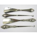 Two pairs of silver handled button hooks and shoe horns, Birmingham 1899 and Birmingham 1904