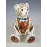 A Royal Crown Derby Collectors' Guild bone china Teddy bear with blue bow-tie paperweight, with gold