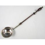 An 18th Century white metal toddy ladle with baluster-turned wooden handle, the bowl bearing
