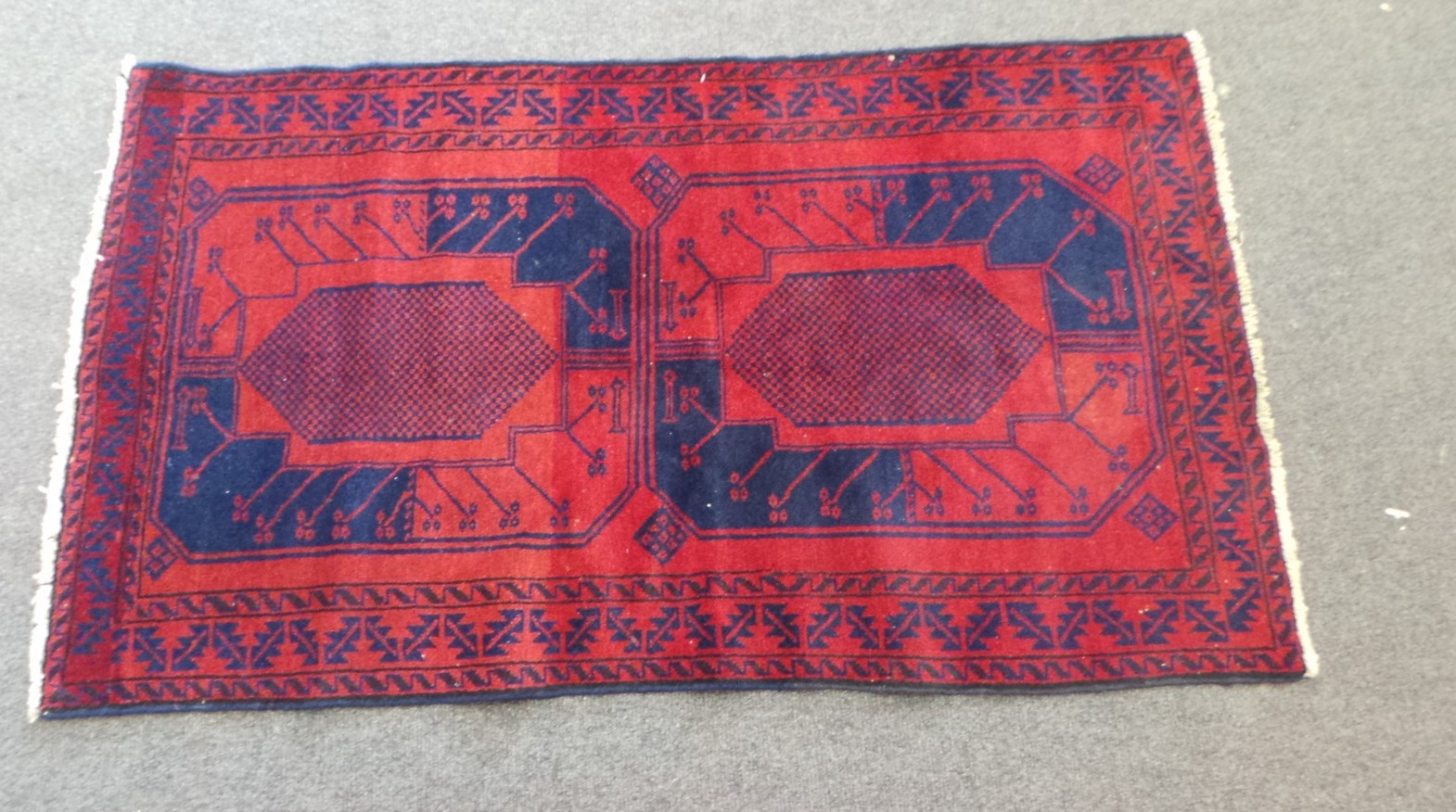 Afghan Beluchi Tribal Rug prominently Red & Blue colours with a large Bacara Design