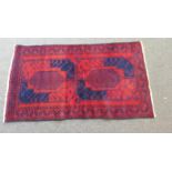 Afghan Beluchi Tribal Rug prominently Red & Blue colours with a large Bacara Design