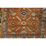 Kurdish rug with all-over geometric design on a salmon ground with borders,