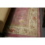 Chinese floral embossed woollen carpet on a pink ground,