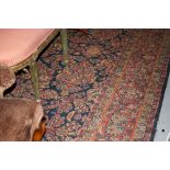 Large machine woven Persian pattern carpet with all-over floral design on a dark blue ground