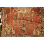 Antique North Persian rug on a wine ground (a/f)