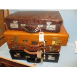 Three leather briefcases and a simulated crocodile leather attache case