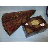 Oriental hardwood brass and jadeite mounted jewellery box and a large ornamental lacquer fan