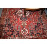 Heriz rug with central medallion and multiple borders on red and blue ground