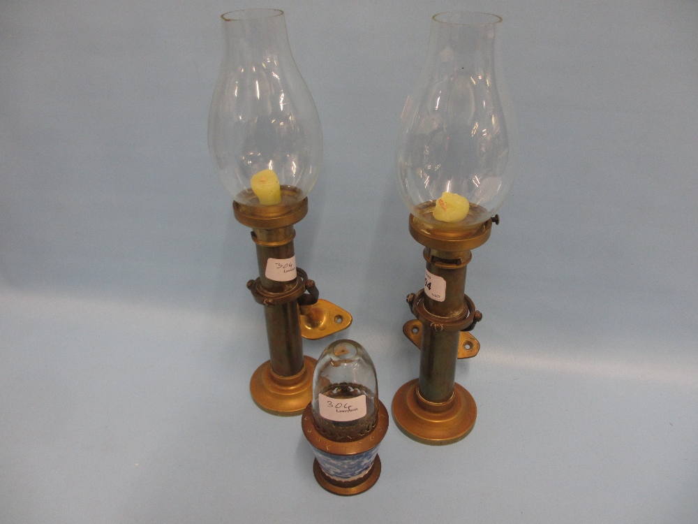 Pair of late 19th or early 20th Century brass ships candlesticks with glass shades and fitted