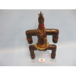 Early 20th Century West African Namchi fertility doll mounted on a Perspex stand,