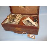 Small brown case containing a quantity of various postcards etc.