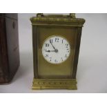 Early 20th Century brass cased carriage clock, the circular enamel dial with Arabic numerals,