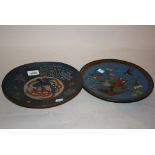 Pair of early 20th Century cloisonne wall plates with floral and bird decoration on a blue ground,