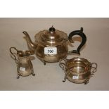 Silver three piece bachelor's teaset with ebonised handle on low cabriole supports (a/f)