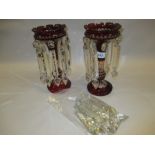 Pair of red overlay glass lustres with cut prismatic drops (a/f)