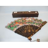 Chinese lacquered and hand painted fan decorated with figures and buildings in a fitted lacquered
