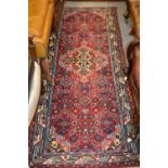 Hamadan runner with medallion and all-over Herati design on a red ground with borders,