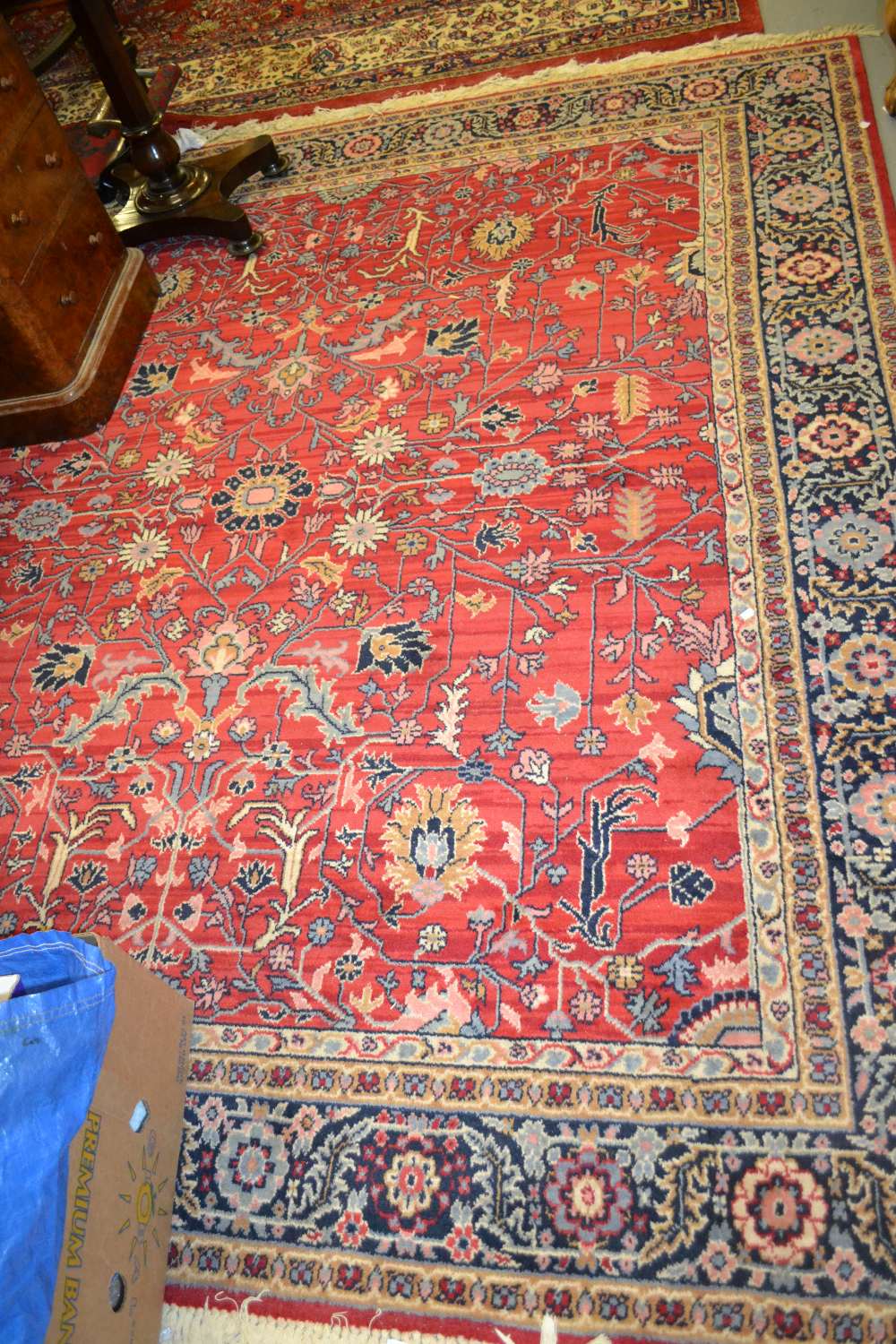 Persian design rug with all-over floral pattern on a red ground with borders,