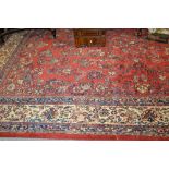 20th Century Saruq carpet with an all-over floral design on a red ground with multiple borders,