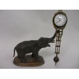 Dark patinated spelter mystery clock in the form of an elephant,