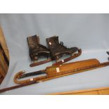 Pair of leather ice skates with covers, a cricket bat,