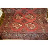 Turkoman rug with two rows of five gols on a red ground with borders,